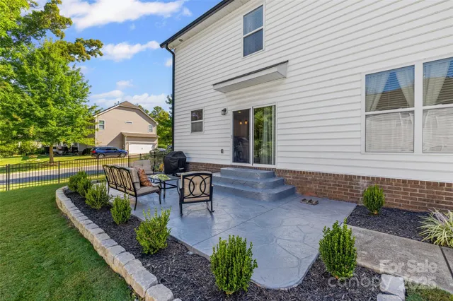a view of a house with backyard and sitting area
