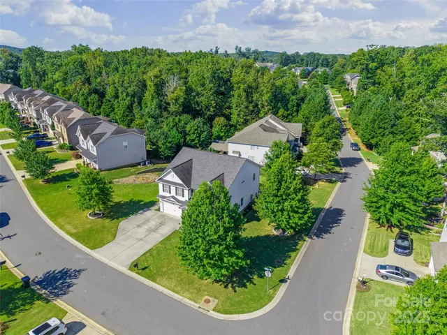 an aerial view of multiple houses with yard