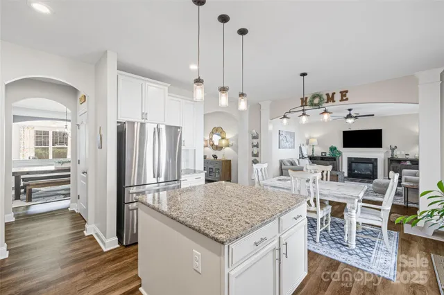 a kitchen with stainless steel appliances kitchen island granite countertop a refrigerator and microwave