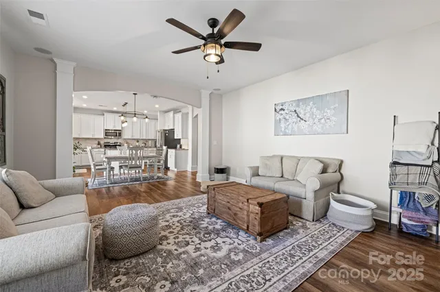 a living room with furniture ceiling fan and a rug