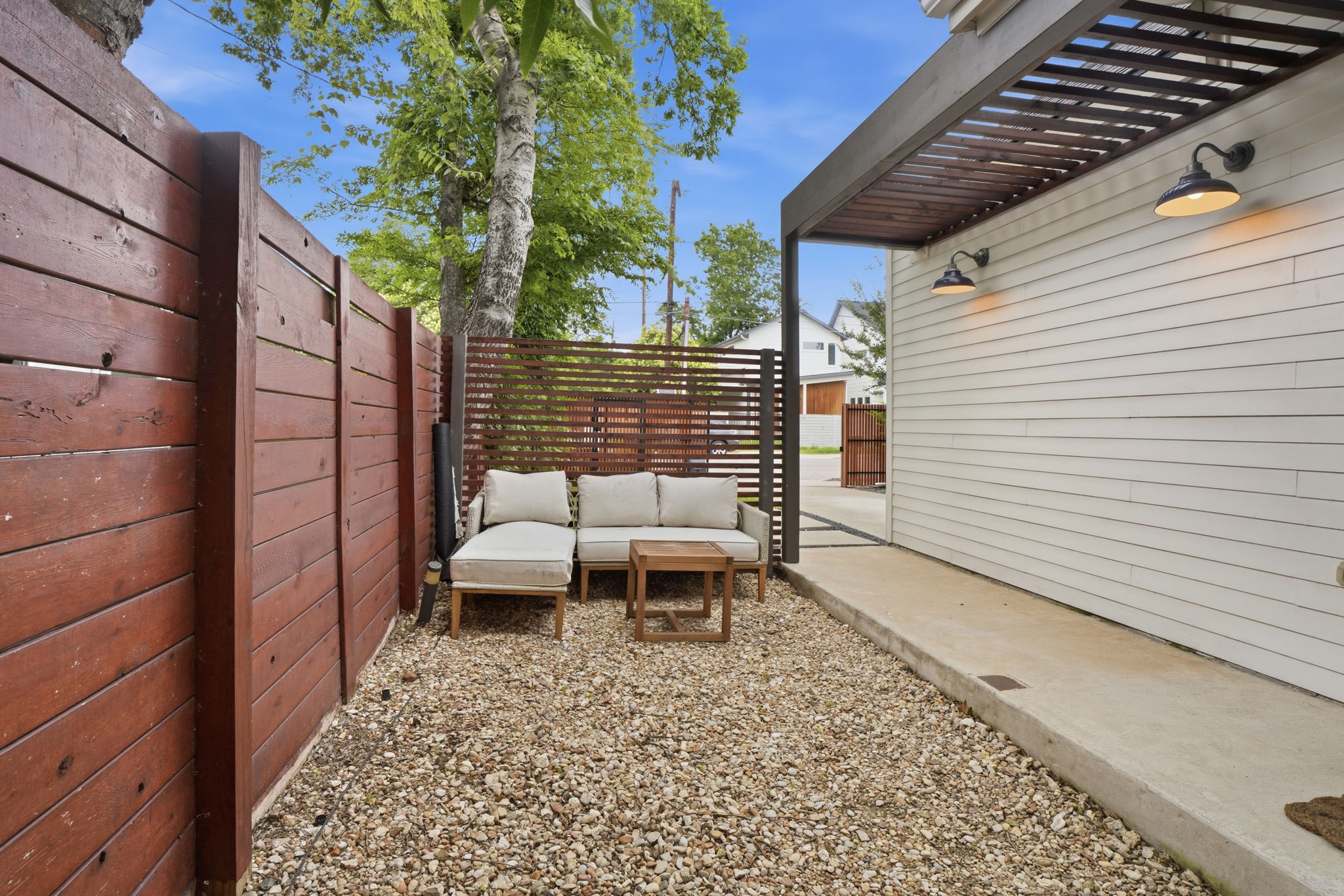 4609 Sara Drive, Unit B Austin, TX 78721 - Photo 5 of 39 A tranquil outdoor sitting area with privacy fencing, perfect for quiet enjoyment.