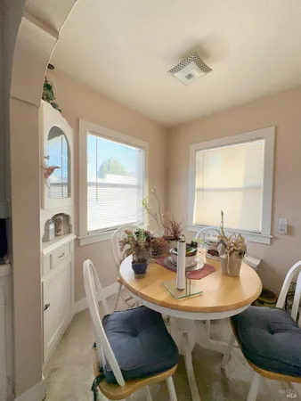 a view of a dining room with furniture and window