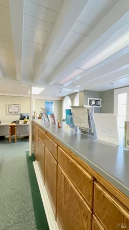 a view of a living room with furniture and a kitchen