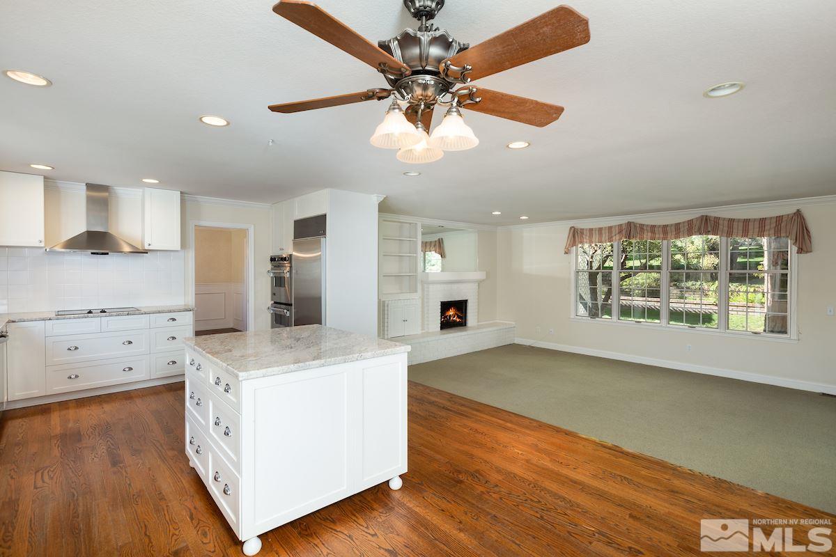 2512 Lake Ridge Shores Circle Reno, NV 89519 - Photo 3 of 25 a large kitchen with stainless steel appliances granite countertop a sink a stove cabinets and wooden floor