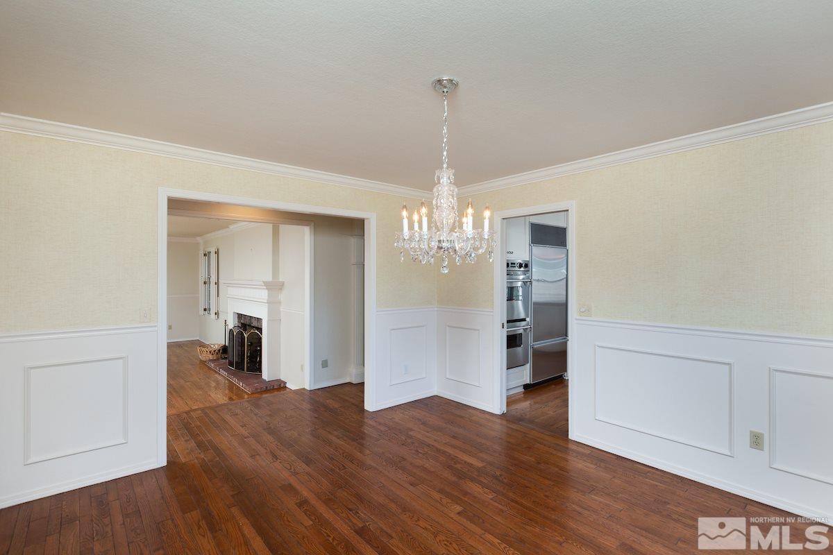 2512 Lake Ridge Shores Circle Reno, NV 89519 - Photo 7 of 25 a view of empty room with wooden floor and kitchen