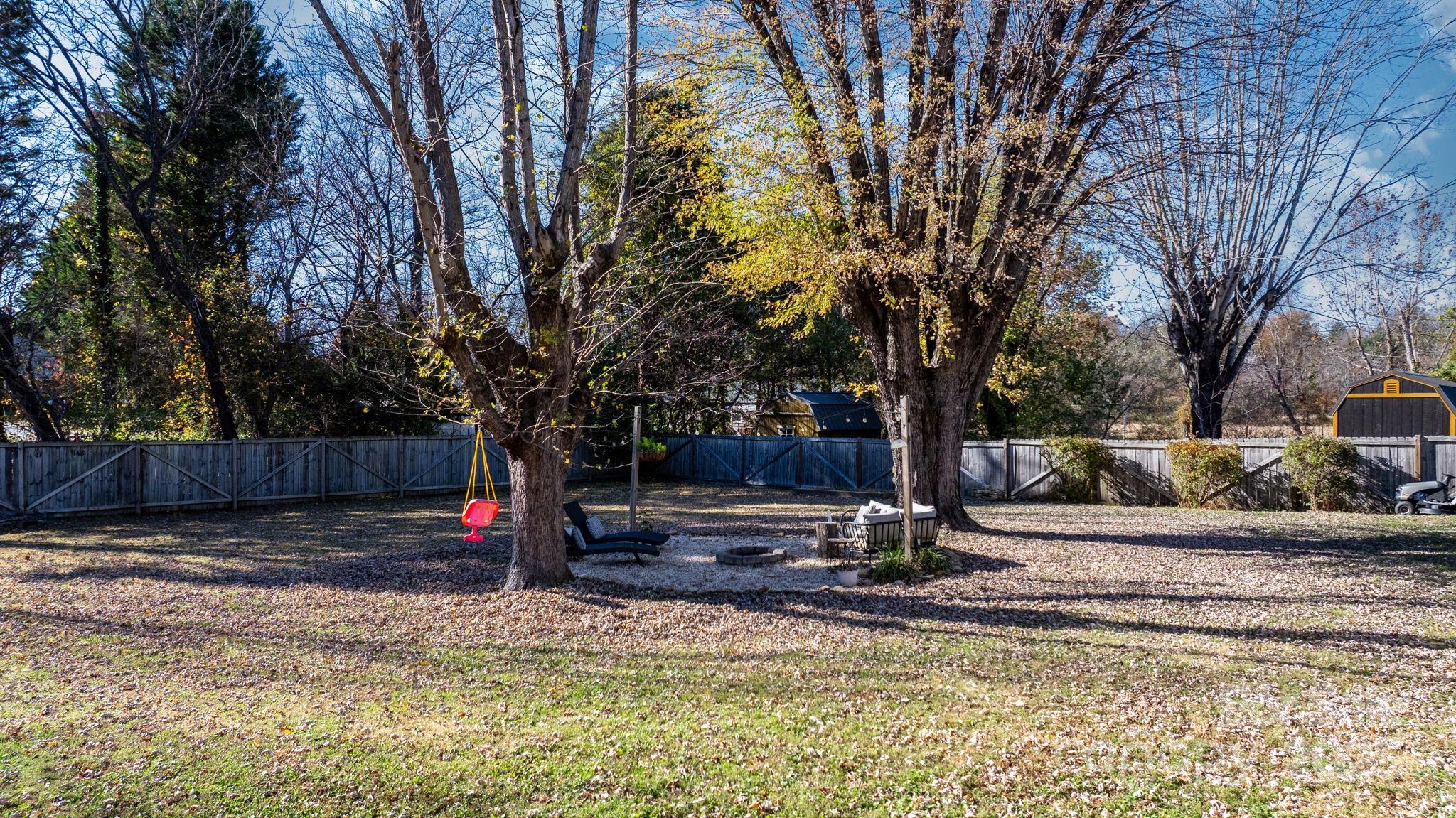 631 Powell Road Northeast Lenoir, NC 28645 - Photo 11 of 38 a view of a backyard with a tree