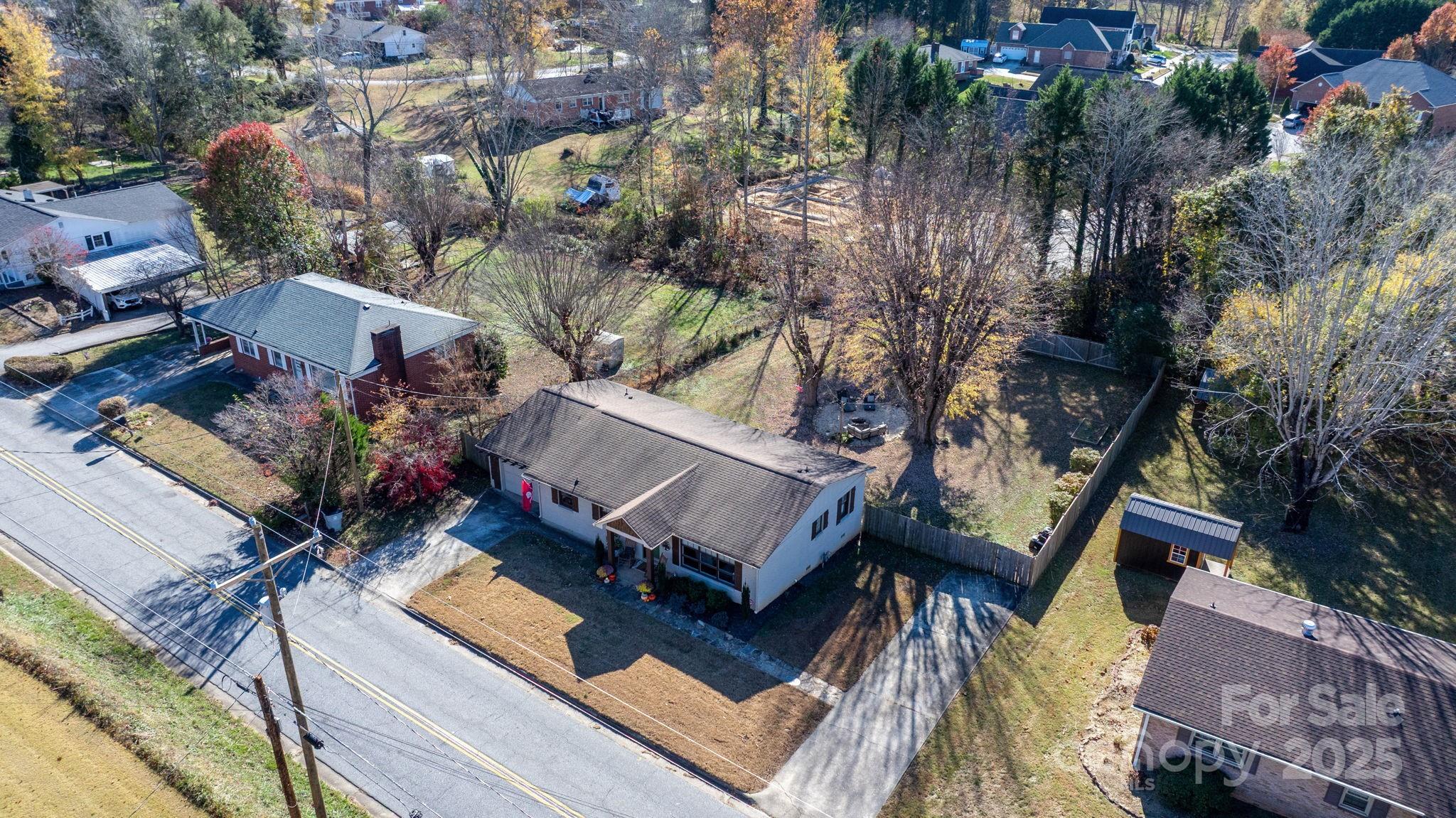 631 Powell Road Northeast Lenoir, NC 28645 - Photo 15 of 38 an aerial view of a house with a yard and lake view