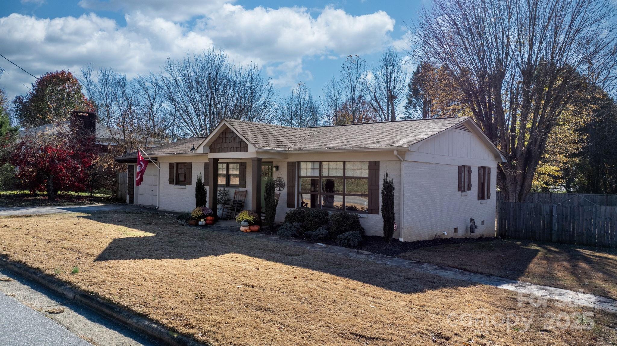 631 Powell Road Northeast Lenoir, NC 28645 - Photo 2 of 38 a view of a white house with a yard covered with snow