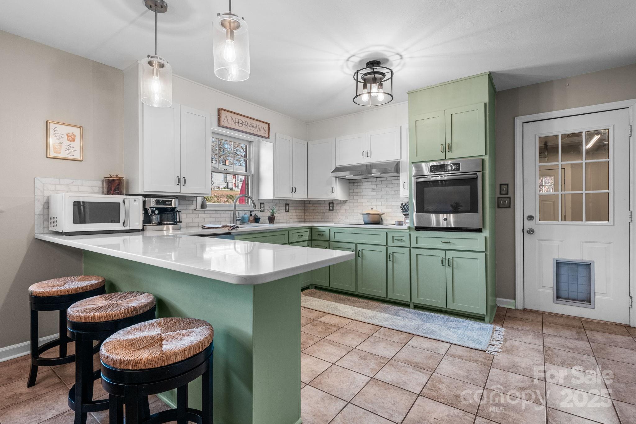 631 Powell Road Northeast Lenoir, NC 28645 - Photo 23 of 38 a kitchen with a sink cabinets and window