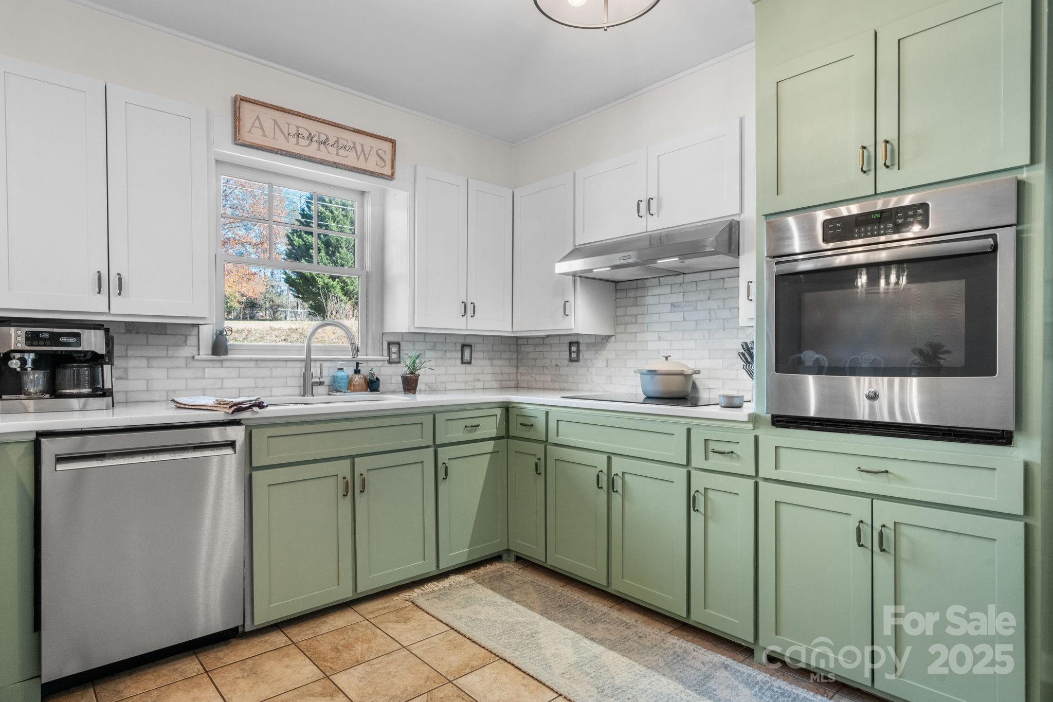 631 Powell Road Northeast Lenoir, NC 28645 - Photo 24 of 38 a kitchen with stainless steel appliances granite countertop a sink and cabinets