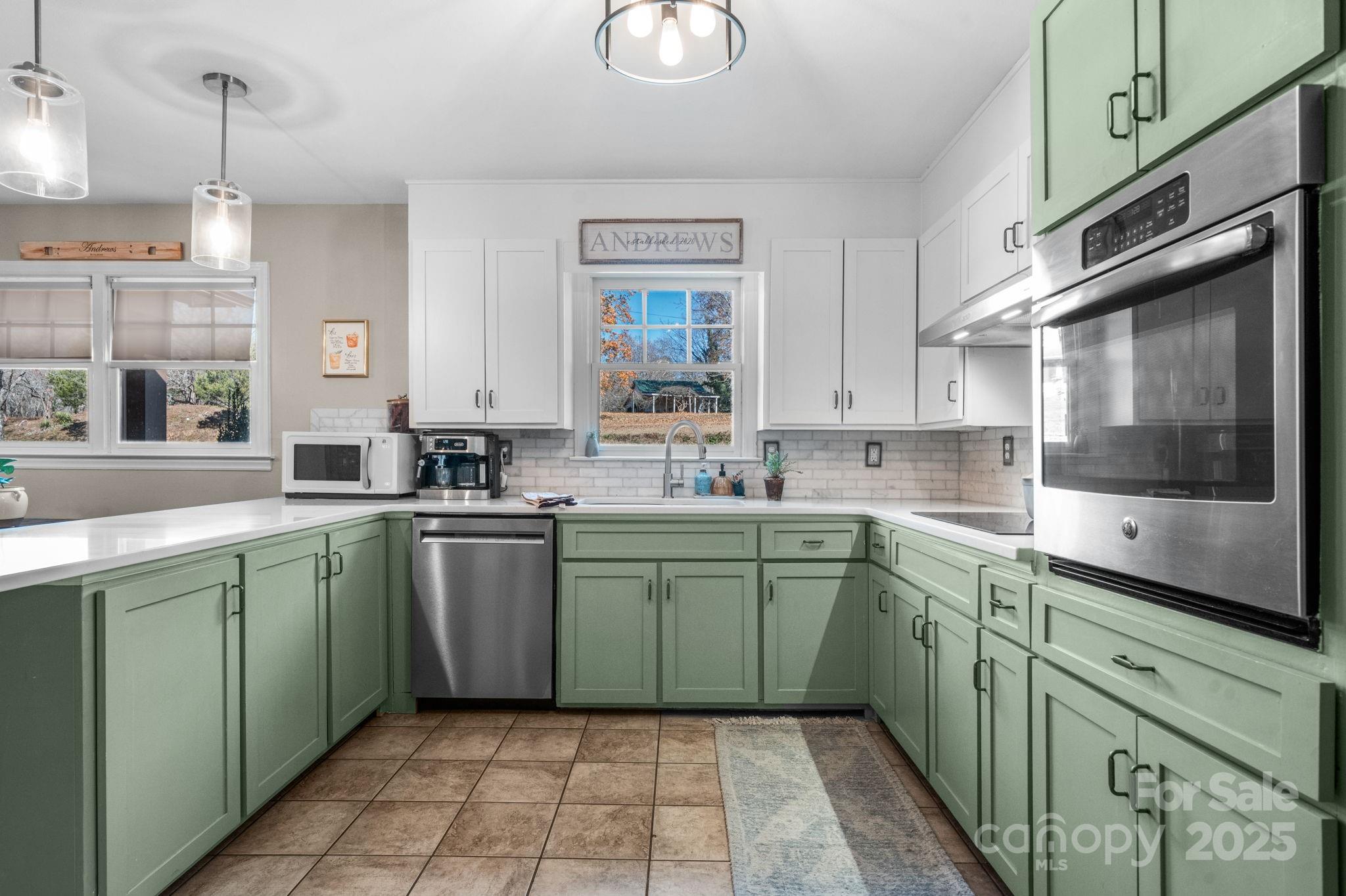 631 Powell Road Northeast Lenoir, NC 28645 - Photo 25 of 38 a kitchen with a sink cabinets and window