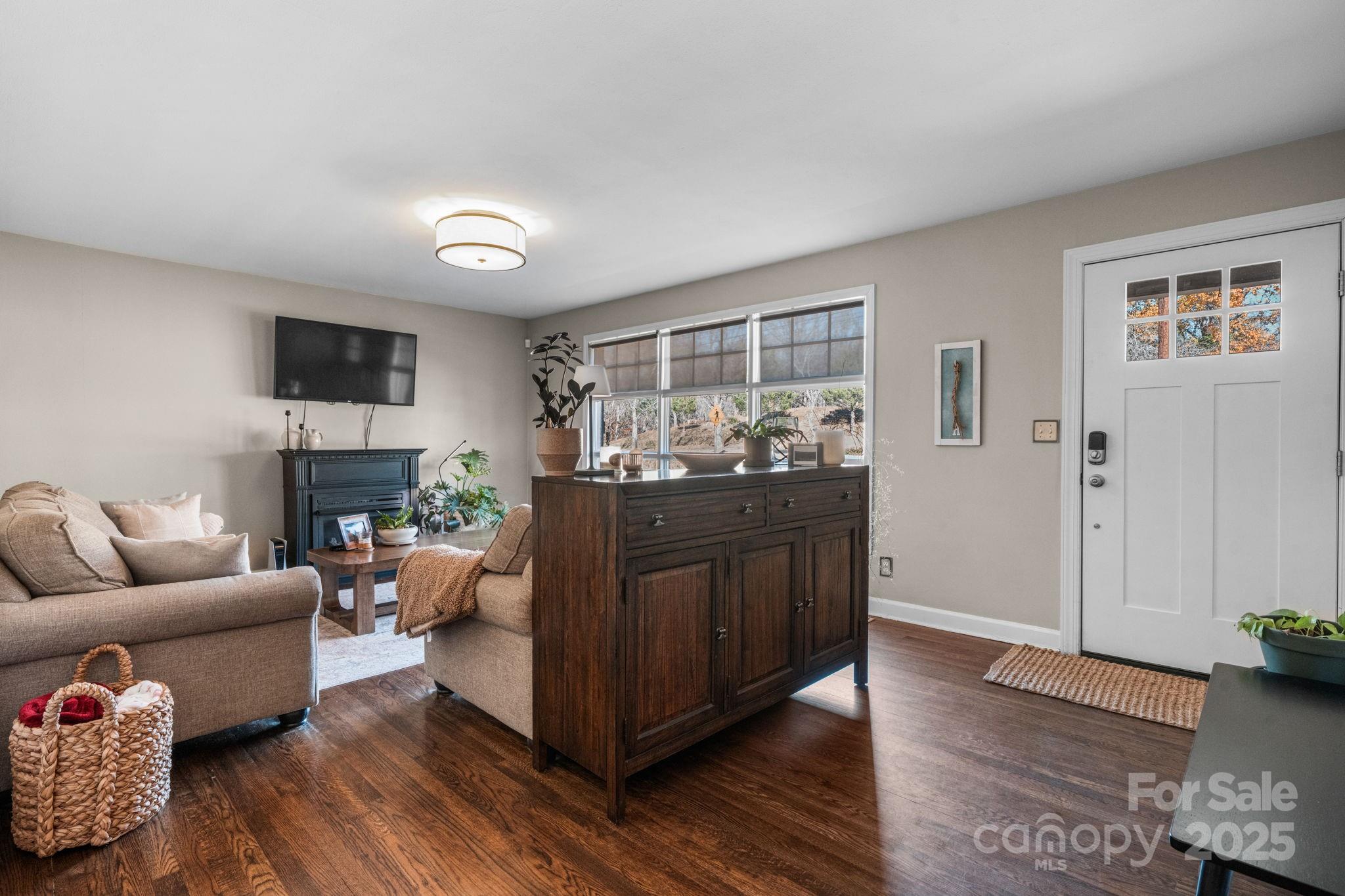 631 Powell Road Northeast Lenoir, NC 28645 - Photo 28 of 38 a living room with furniture and a flat screen tv