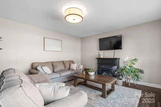 a living room with furniture and a floor to ceiling window