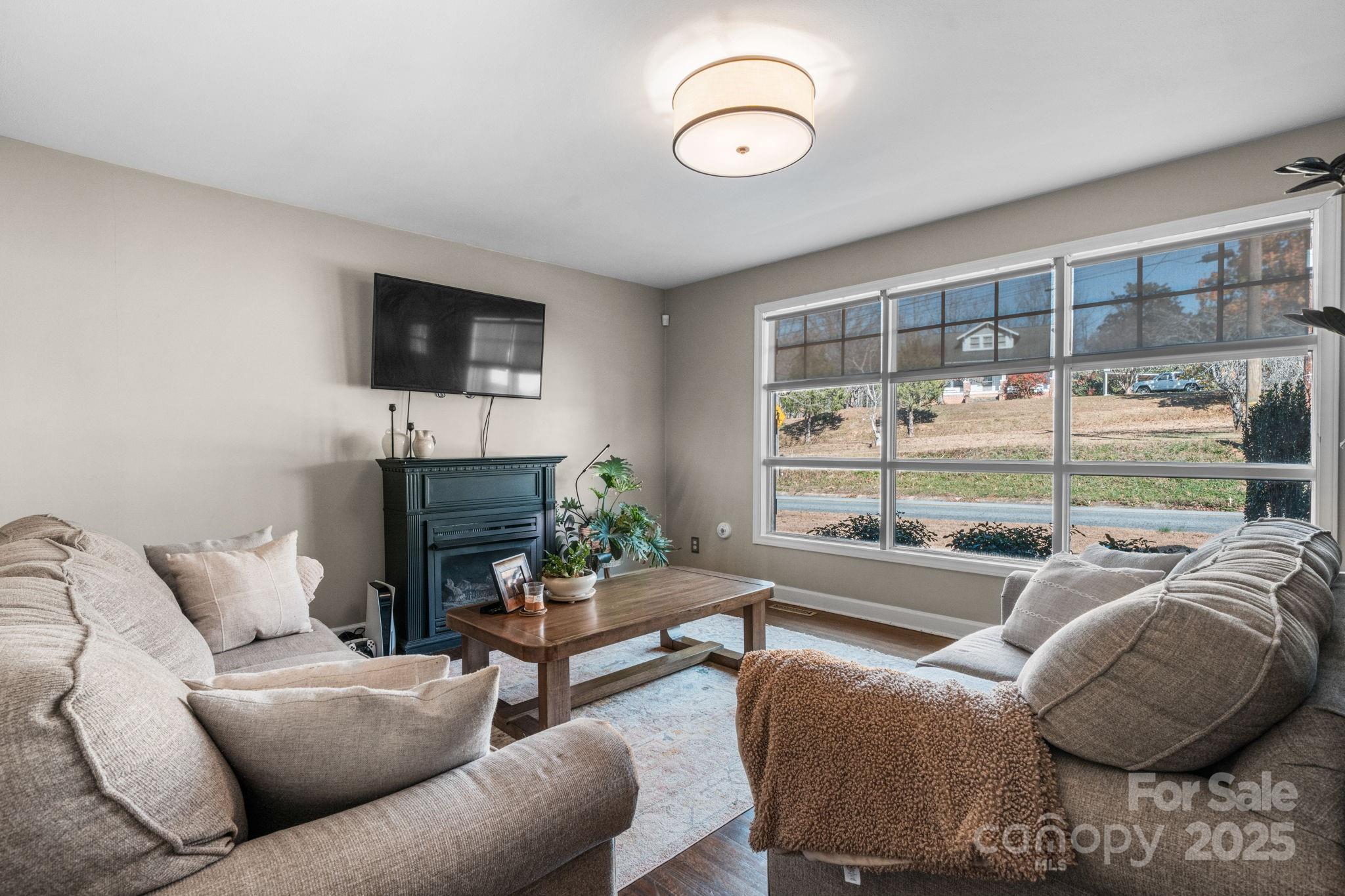 631 Powell Road Northeast Lenoir, NC 28645 - Photo 30 of 38 a living room with furniture and a floor to ceiling window