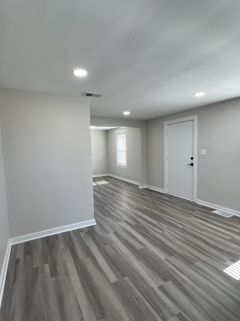 407 Abe Street Plano, IL 60545 - Photo 4 of 15 a view of room window and wooden floor