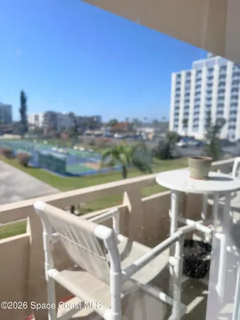 a view of swimming pool with outdoor seating and city view