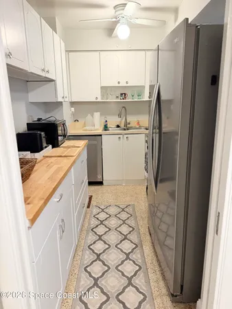 a kitchen with a refrigerator sink stove and cabinets