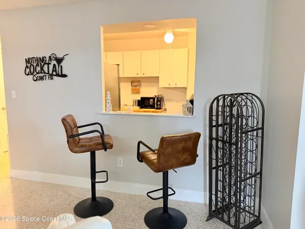 a view of a room with a window and wooden floor