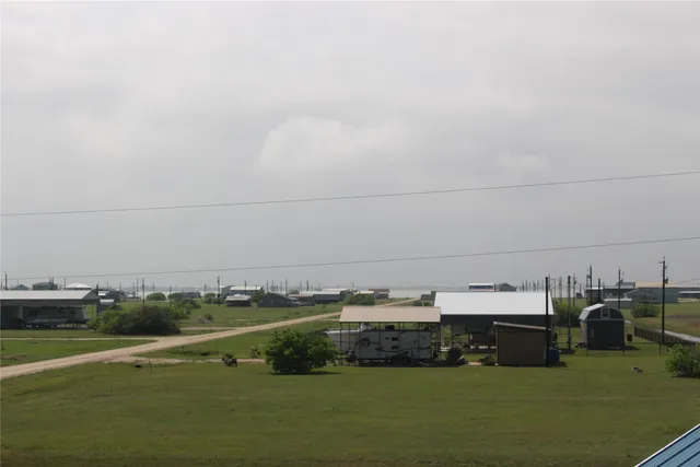a view of a town with lawn chairs and couches