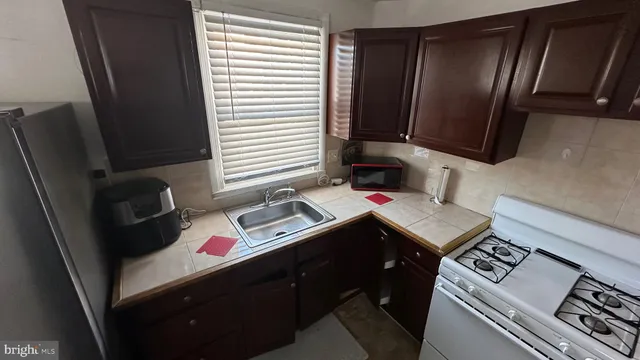 a kitchen with a sink stove and refrigerator