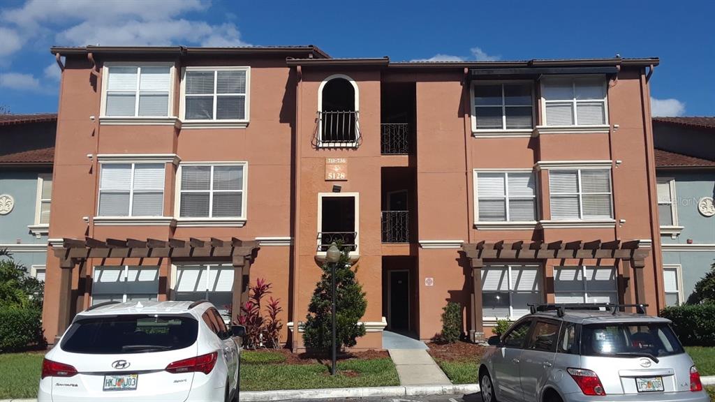 5128 Conroy Road, Unit 25 Orlando, FL 32811 - Photo 1 of 1 a car parked in front of a building