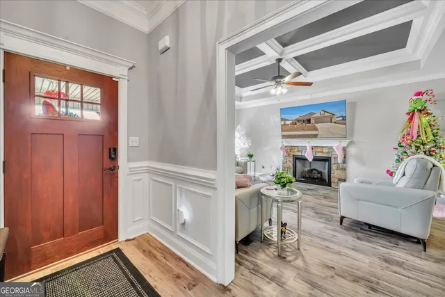 a living room with furniture fireplace and a large window
