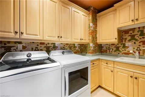 a view of a kitchen with sink and washing machine
