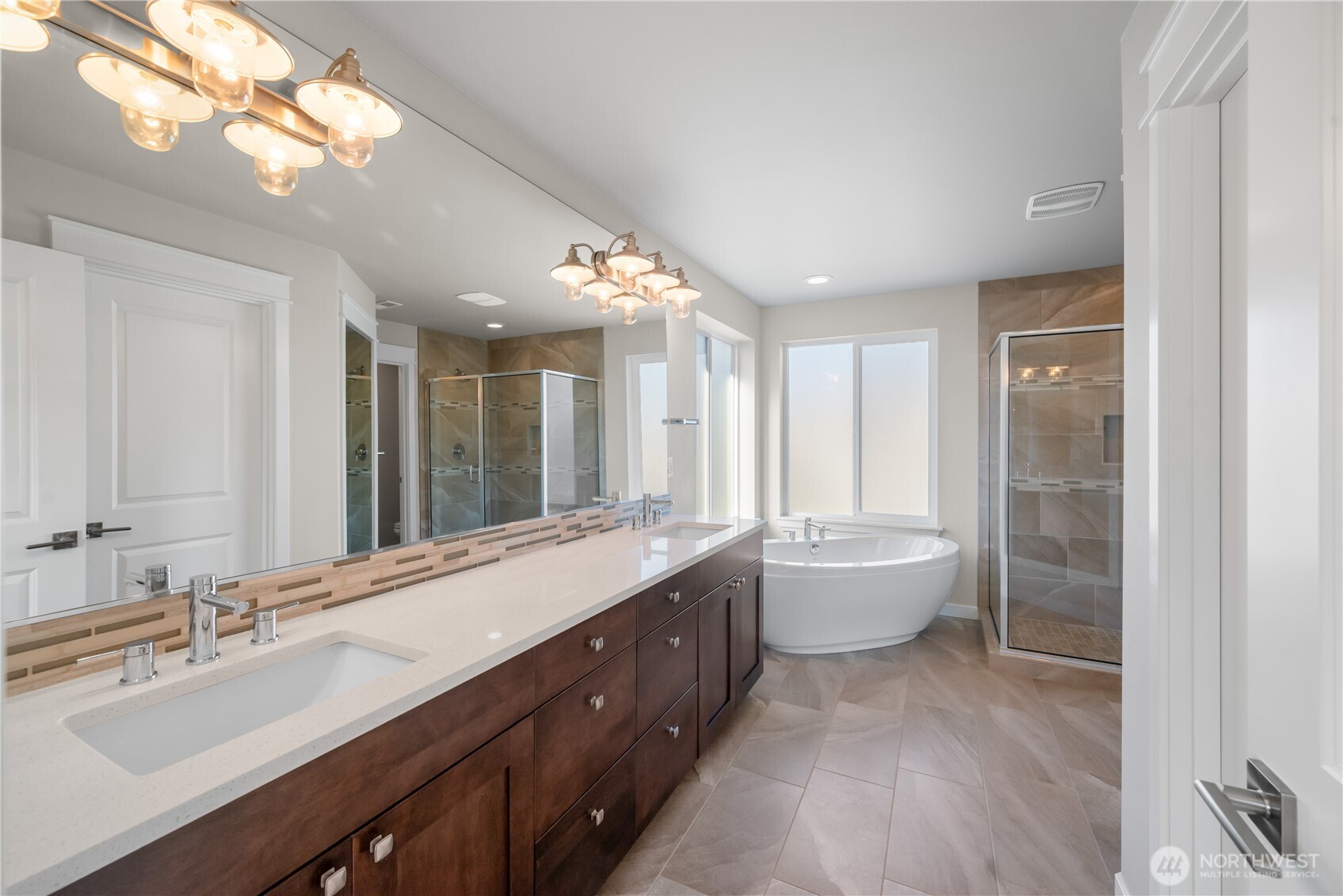 26925 230th Place Southeast Maple Valley, WA 98038 - Photo 14 of 32 a spacious bathroom with a double vanity sink toilet mirror and bathtub