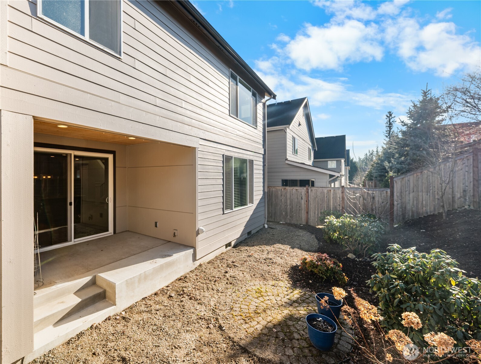 26925 230th Place Southeast Maple Valley, WA 98038 - Photo 27 of 32 a view of a house with a small yard plants and large tree