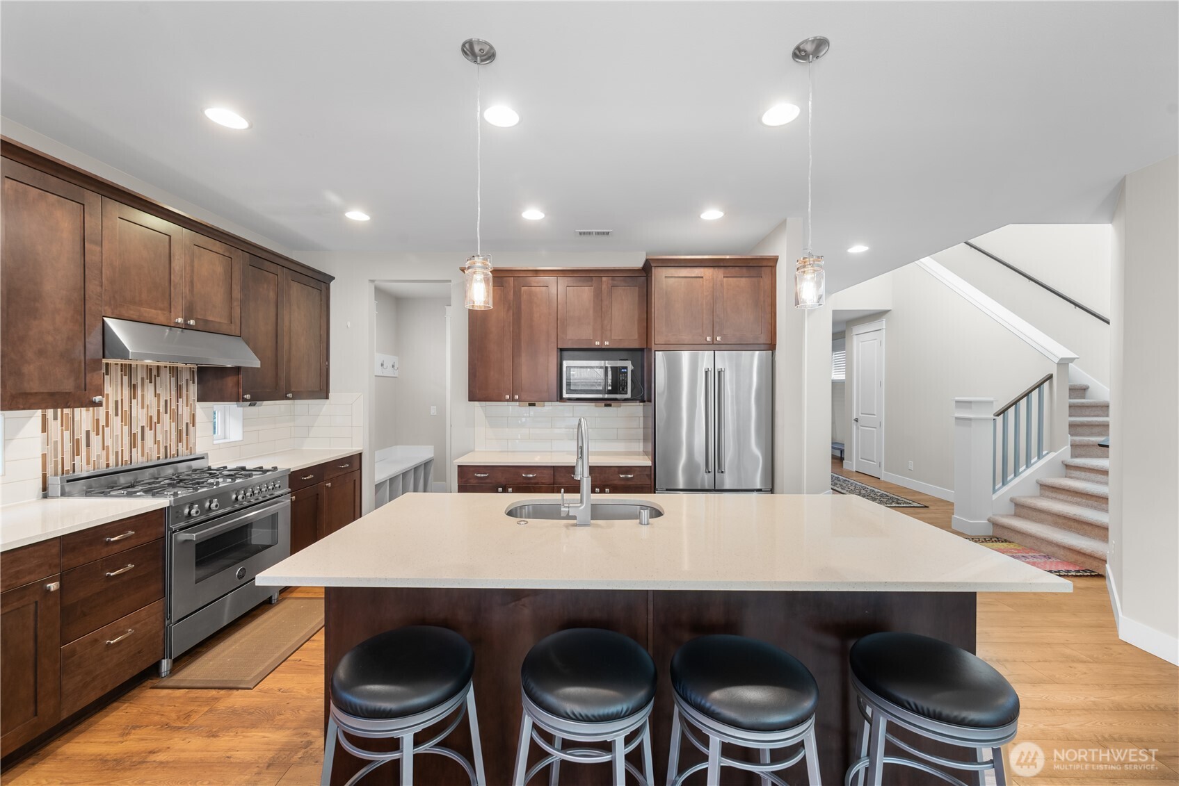 26925 230th Place Southeast Maple Valley, WA 98038 - Photo 4 of 32 a kitchen with kitchen island a table and chairs