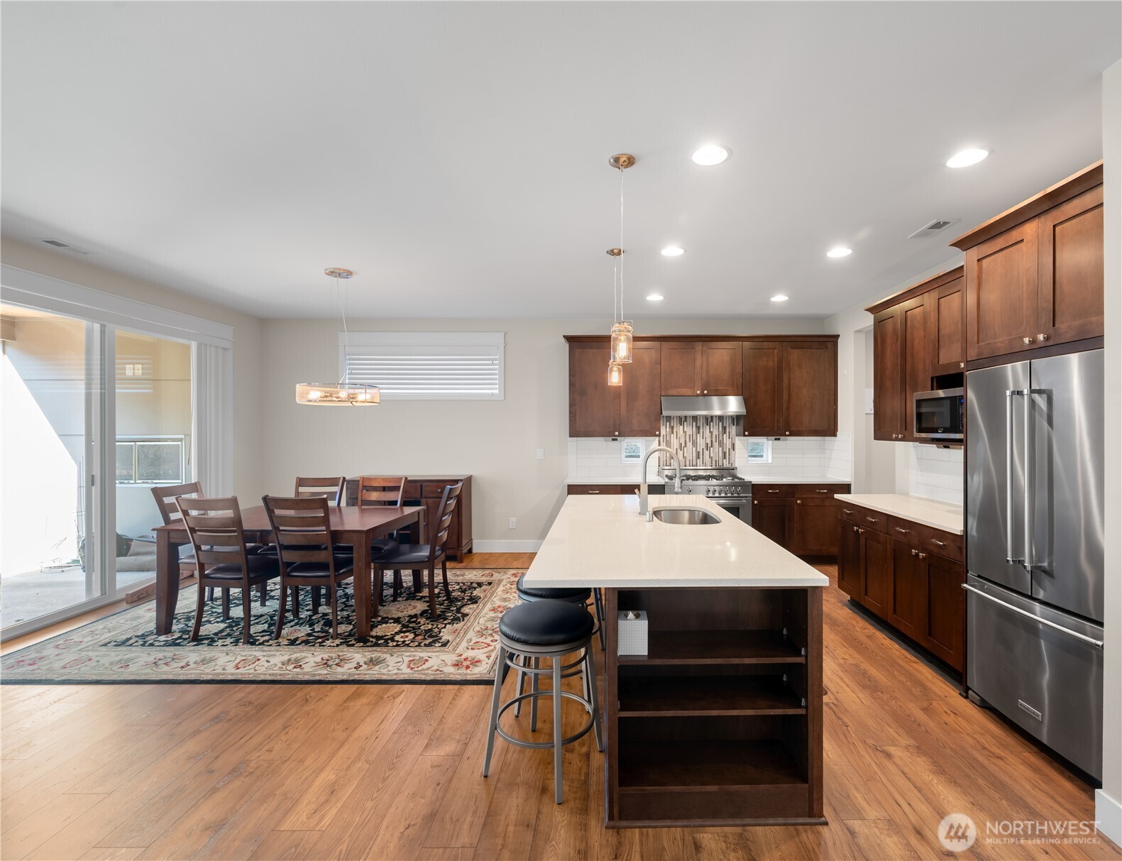 26925 230th Place Southeast Maple Valley, WA 98038 - Photo 5 of 32 a large kitchen with a table and chairs