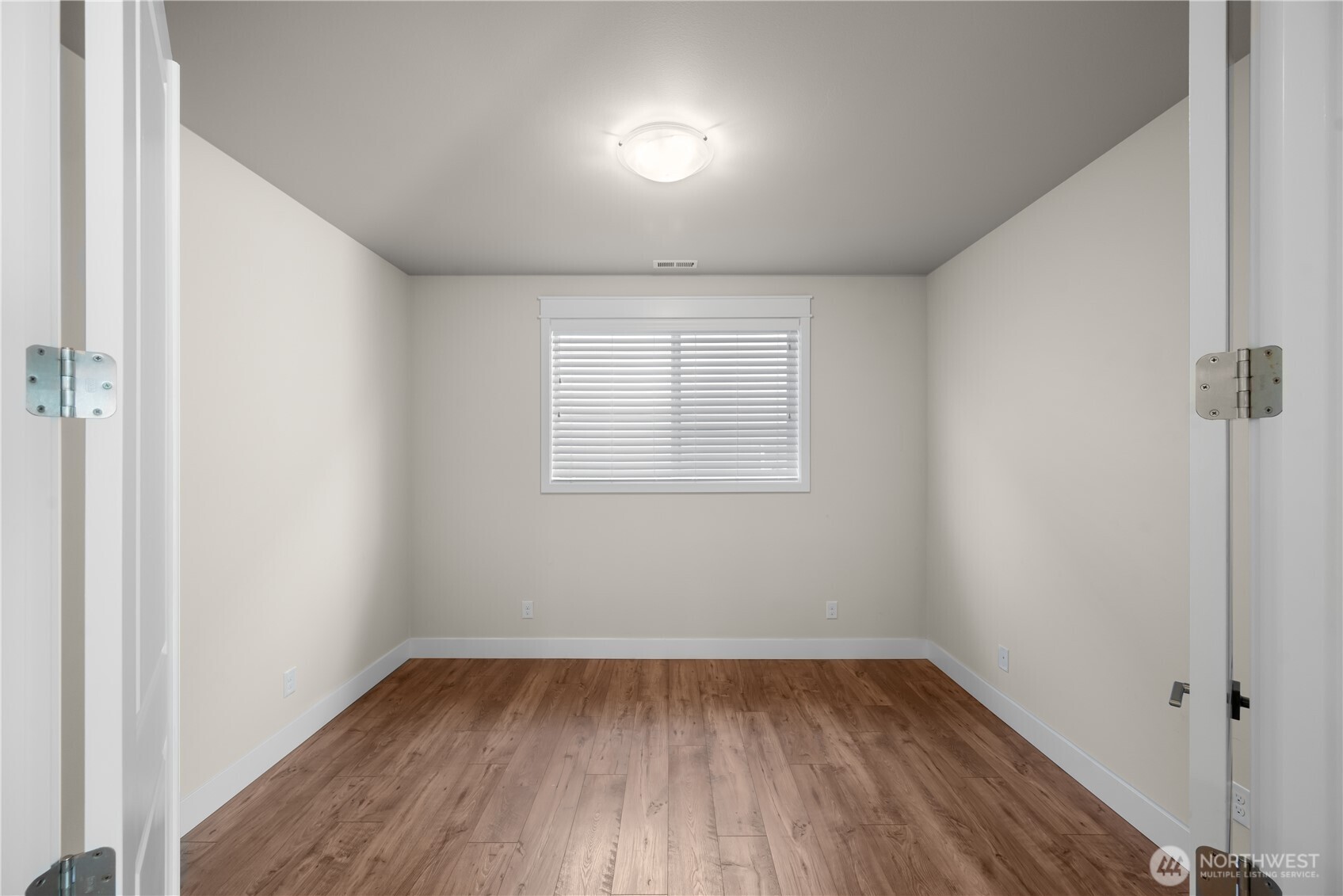 26925 230th Place Southeast Maple Valley, WA 98038 - Photo 9 of 32 an empty room with wooden floor and windows