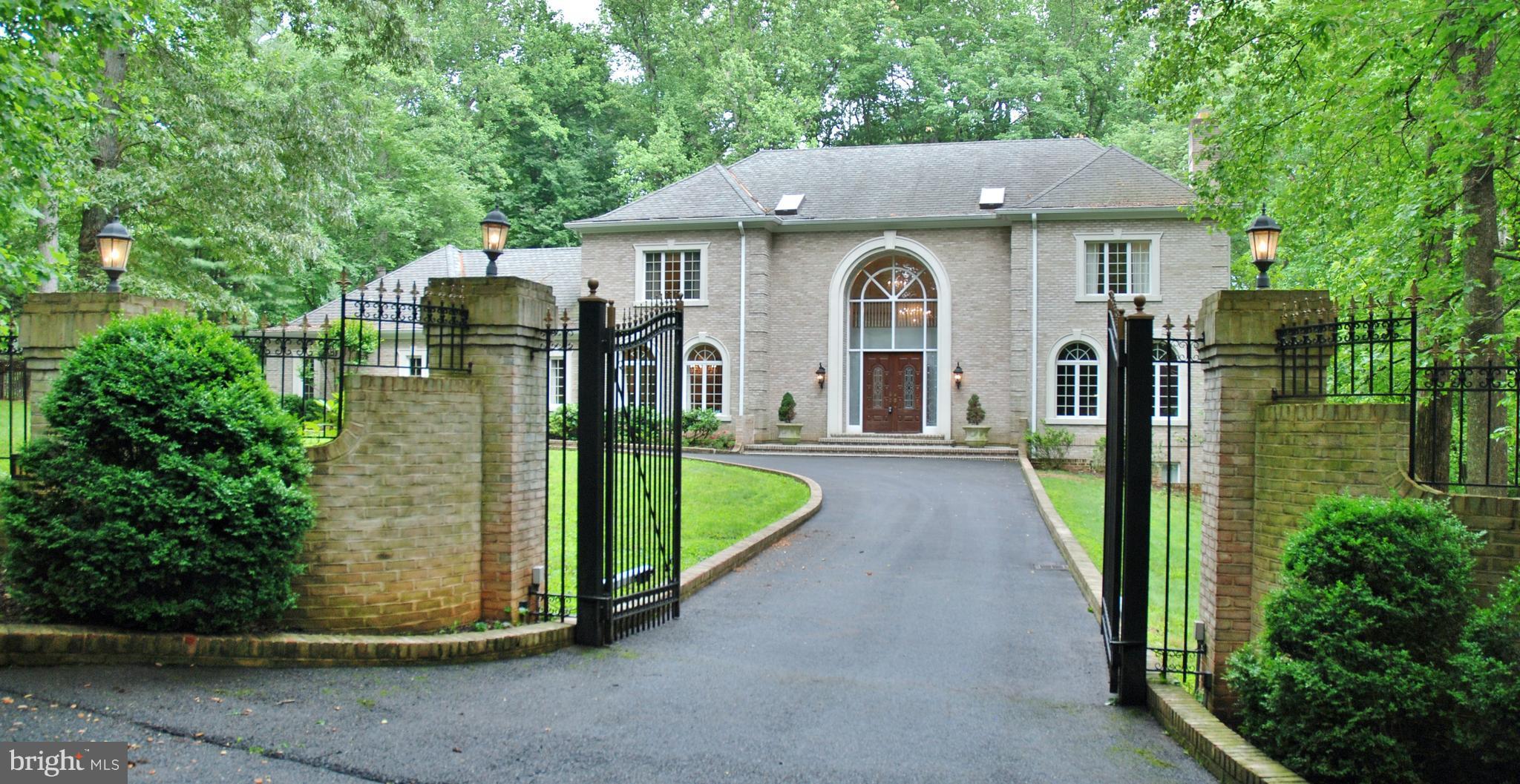 11548 Springridge Road Potomac, MD 20854 - Photo 1 of 30 a front view of a house with a garden and plants