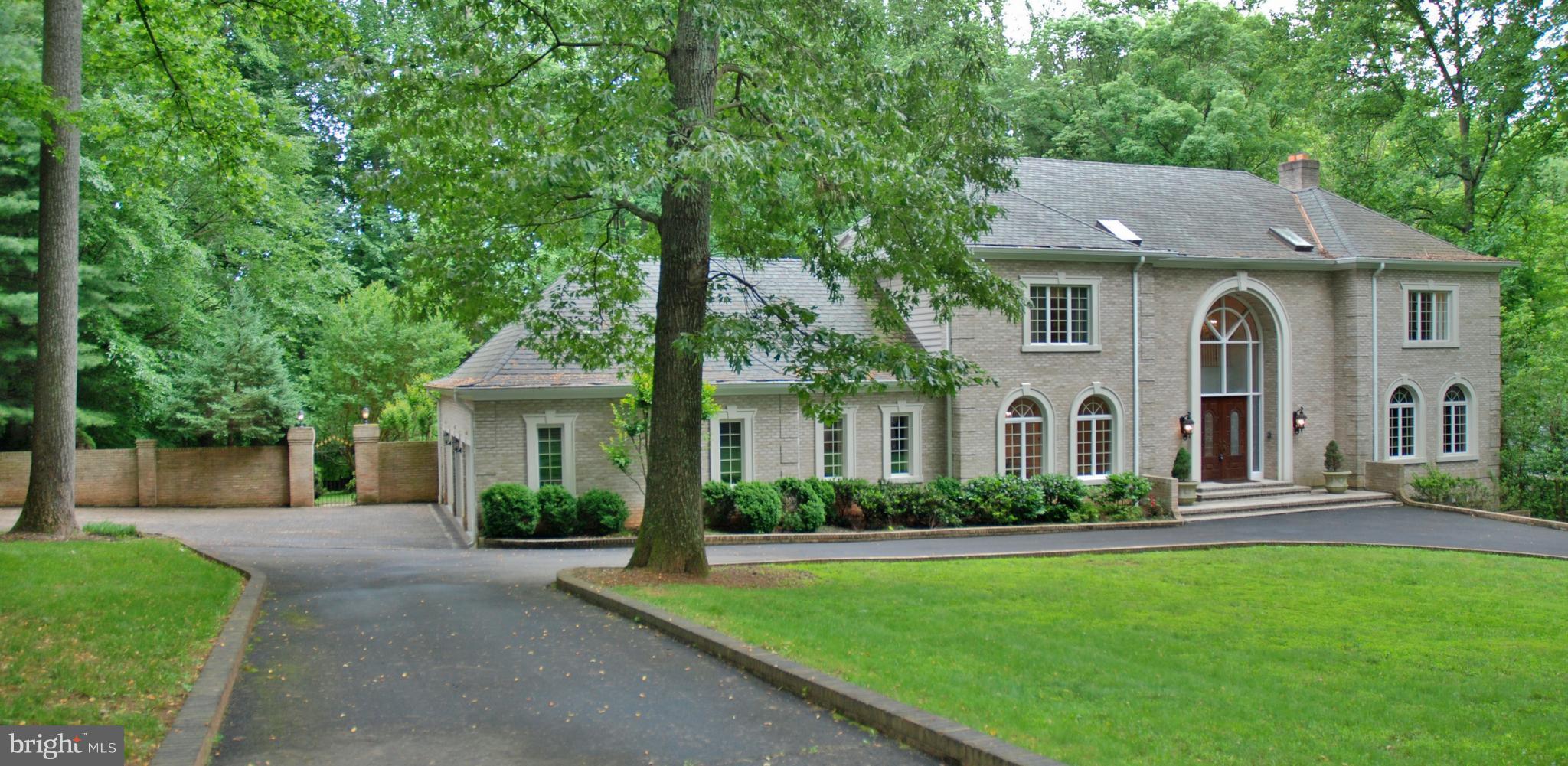 11548 Springridge Road Potomac, MD 20854 - Photo 2 of 30 a front view of a house with a garden and plants