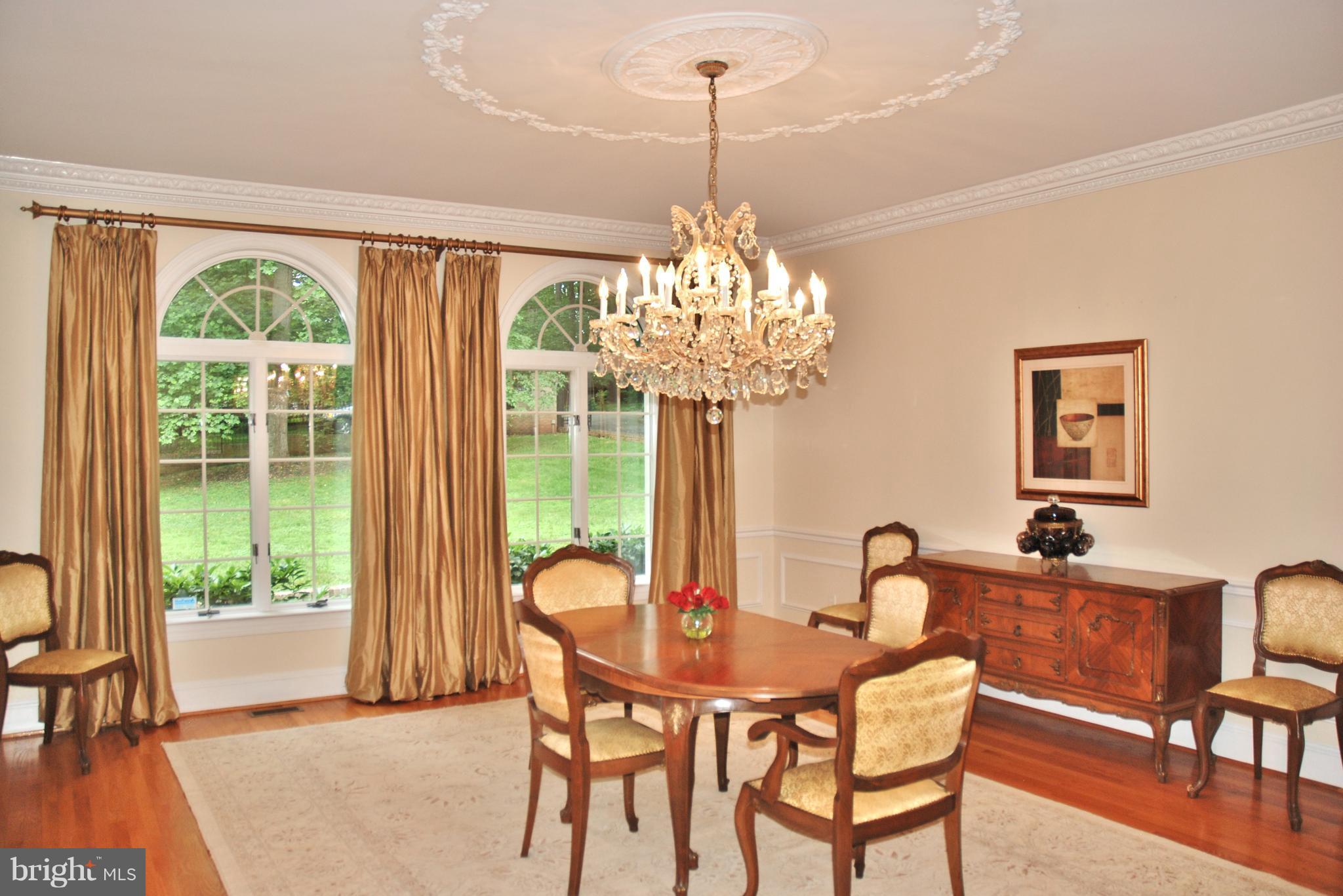 11548 Springridge Road Potomac, MD 20854 - Photo 12 of 30 a dining room with furniture a chandelier and wooden floor