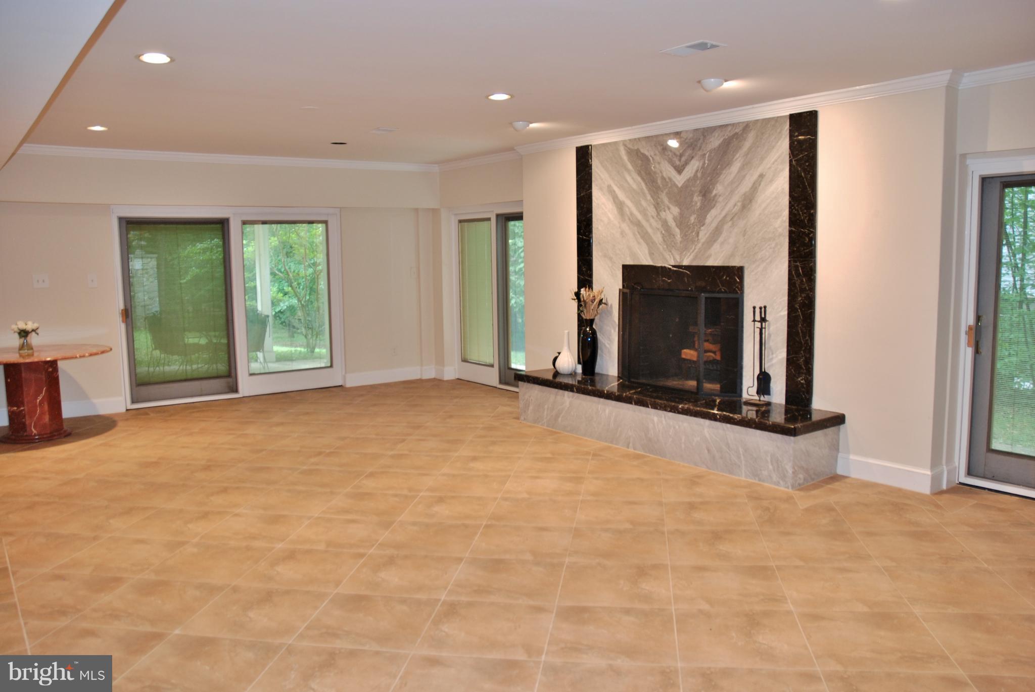 11548 Springridge Road Potomac, MD 20854 - Photo 23 of 30 a view of an empty room with a fireplace and a window
