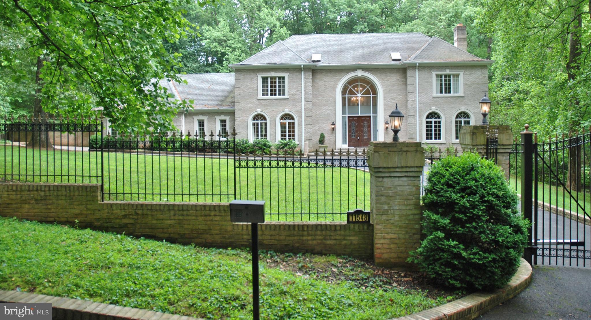 11548 Springridge Road Potomac, MD 20854 - Photo 5 of 30 a front view of a house with a garden