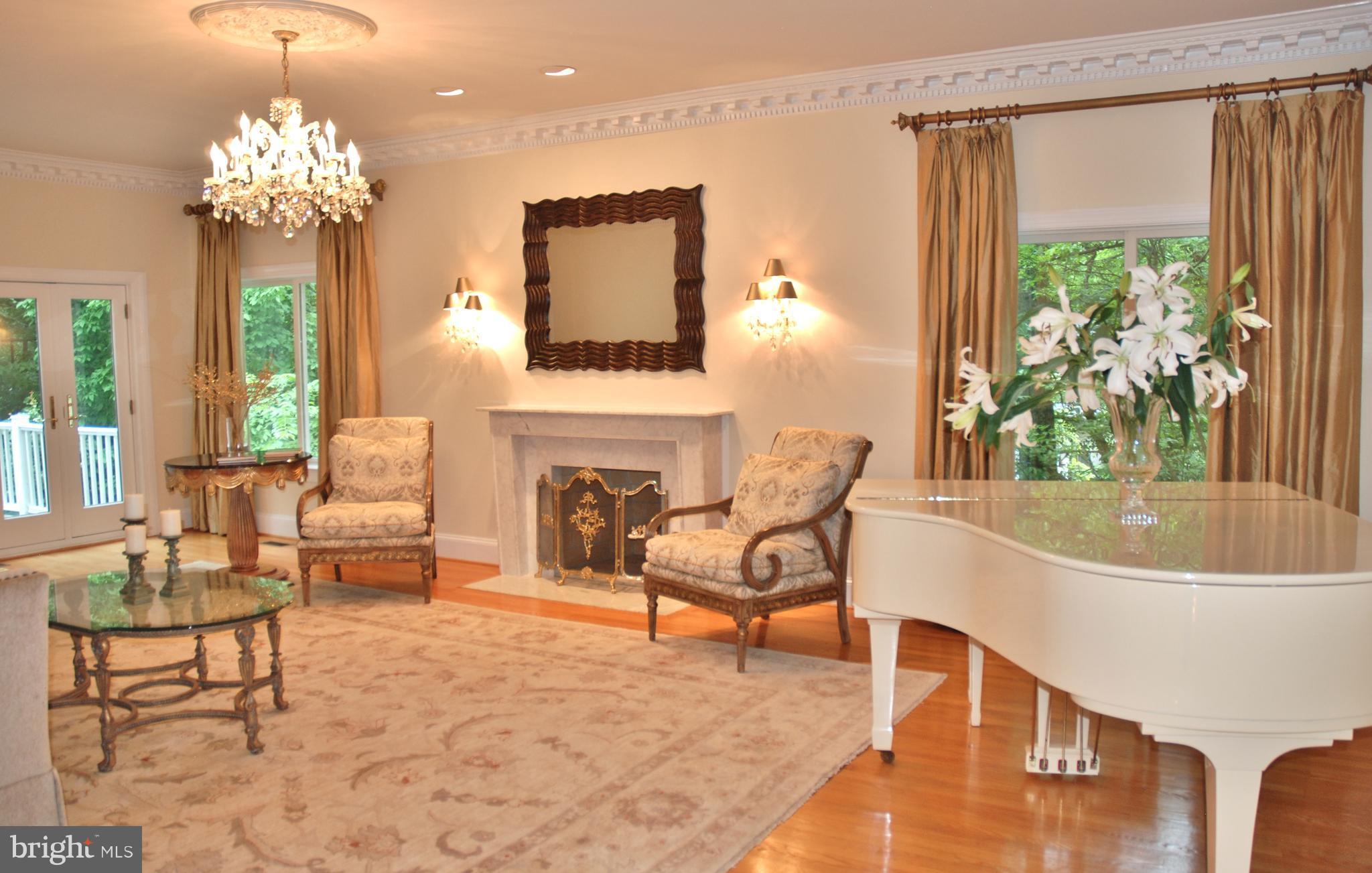 11548 Springridge Road Potomac, MD 20854 - Photo 10 of 30 a living room with fireplace furniture and a chandelier