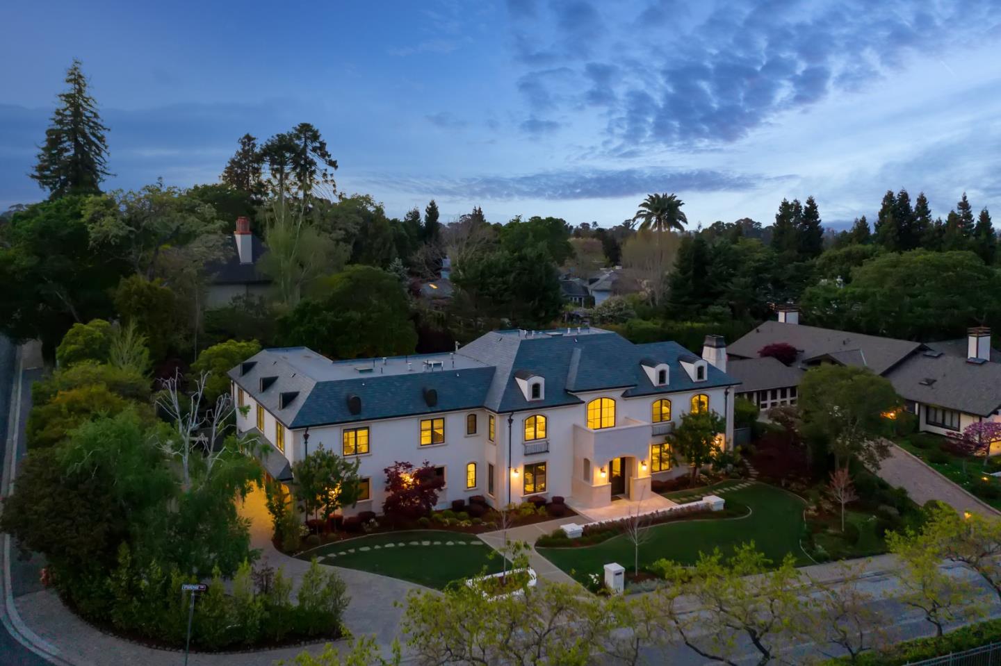 an aerial view of a house with garden space and street view