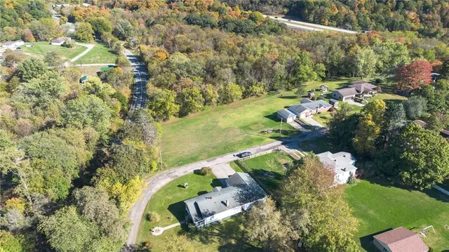 an aerial view of a house with a yard and lake view
