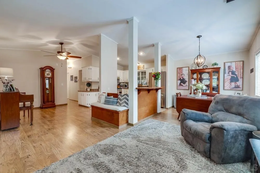 9036 Lemon Avenue La Mesa, CA 91941 - Photo 11 of 28 a living room with furniture a dining table and a chandelier