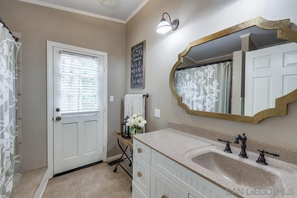 9036 Lemon Avenue La Mesa, CA 91941 - Photo 21 of 28 a bathroom with a sink and a mirror