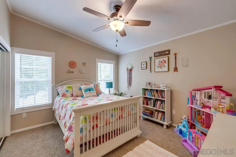 9036 Lemon Avenue La Mesa, CA 91941 - Photo 22 of 28 a bedroom with a bed and a chandelier