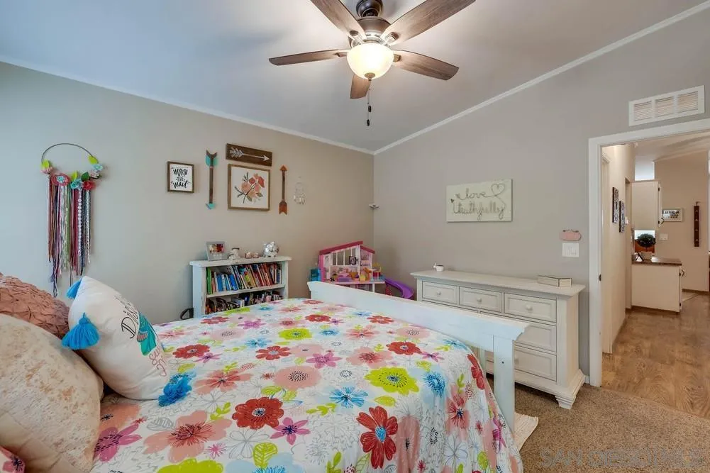 9036 Lemon Avenue La Mesa, CA 91941 - Photo 23 of 28 a bedroom with a bed and a chandelier