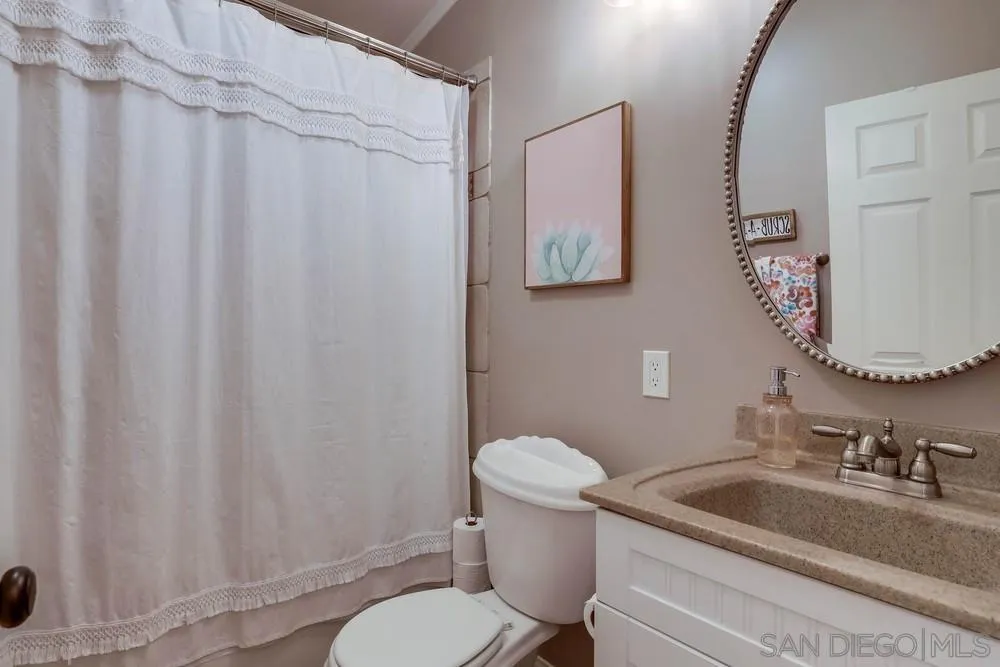 9036 Lemon Avenue La Mesa, CA 91941 - Photo 24 of 28 a white toilet sitting next to a bathroom sink