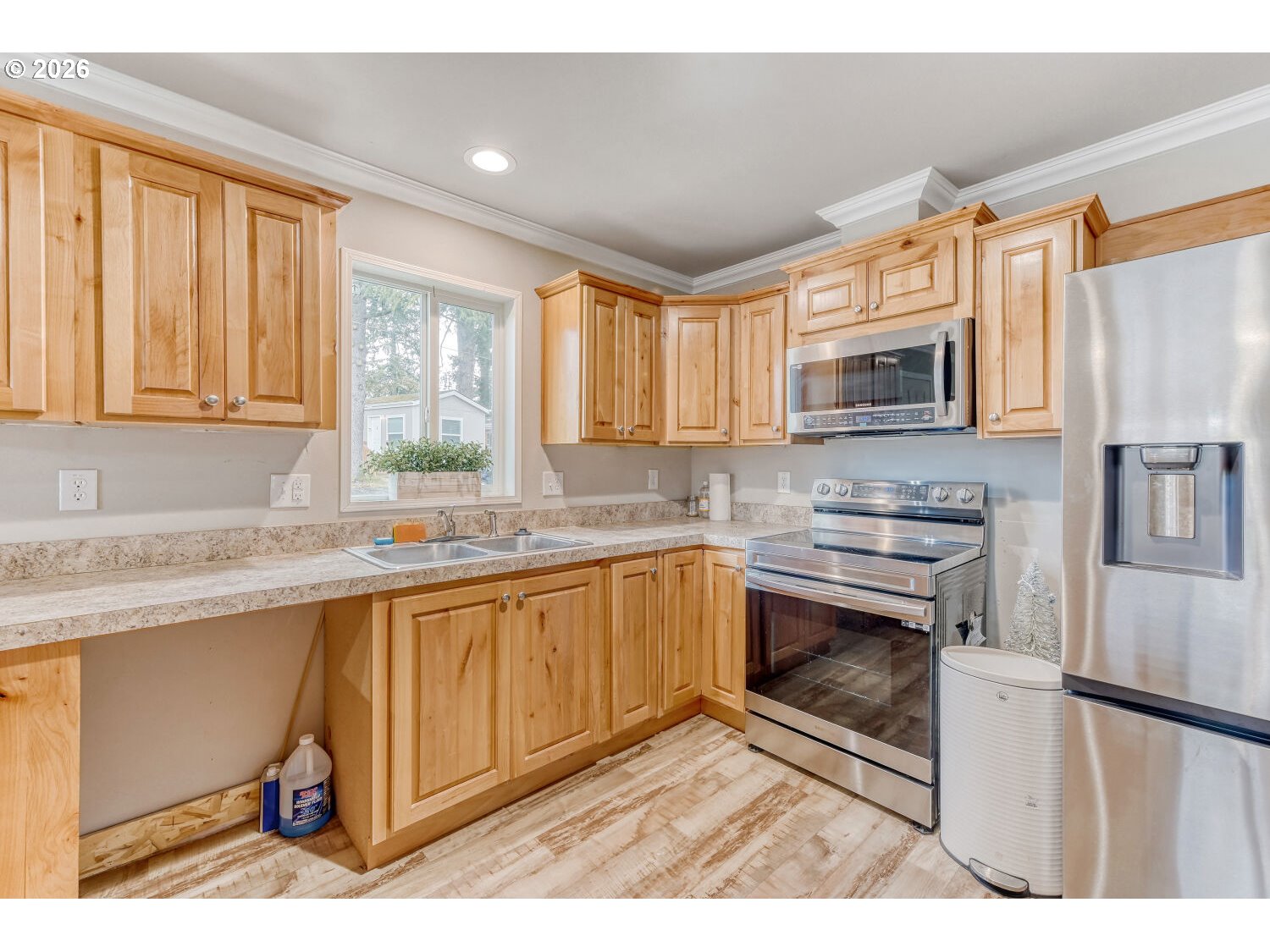 4264 Southeast 122nd Avenue, Unit 13 Portland, OR 97236 - Photo 13 of 30 a kitchen with stainless steel appliances granite countertop a stove a sink and a microwave
