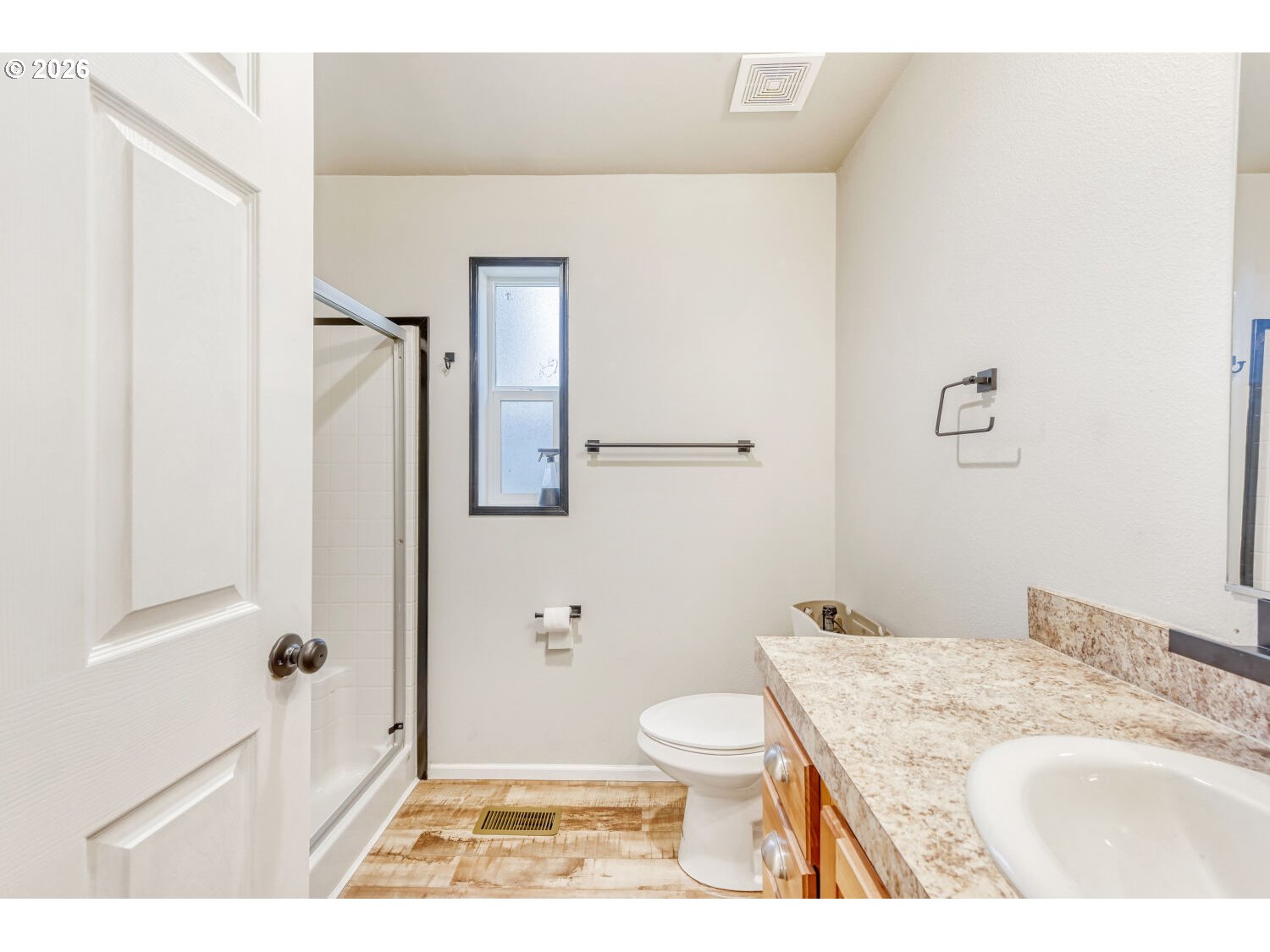 4264 Southeast 122nd Avenue, Unit 13 Portland, OR 97236 - Photo 17 of 30 a bathroom with a granite countertop sink a toilet a mirror and shower
