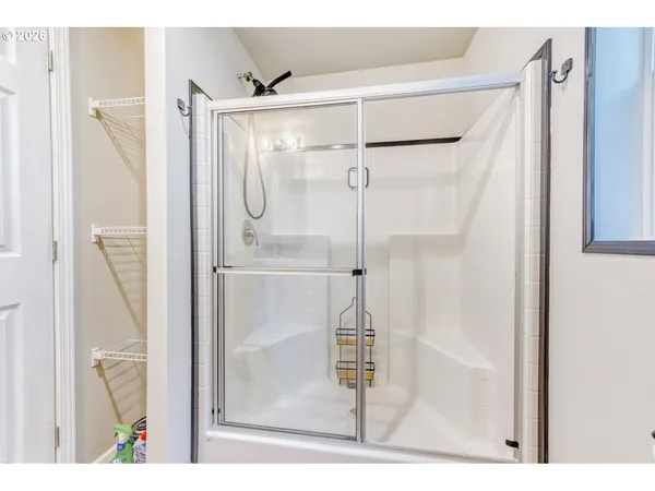 a bathroom with a glass shower door