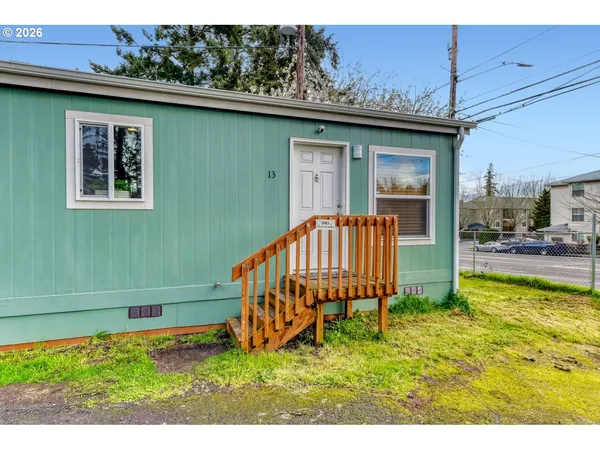 a backyard of a house with table and chairs