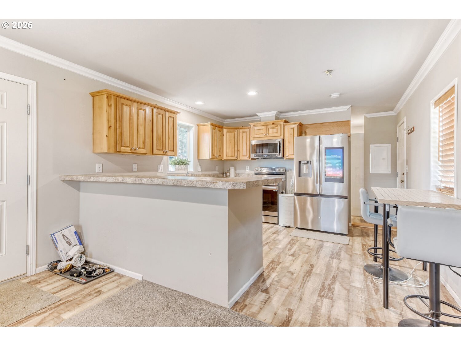4264 Southeast 122nd Avenue, Unit 13 Portland, OR 97236 - Photo 10 of 30 a kitchen with stainless steel appliances granite countertop a stove a sink a refrigerator with white cabinets and wooden floor
